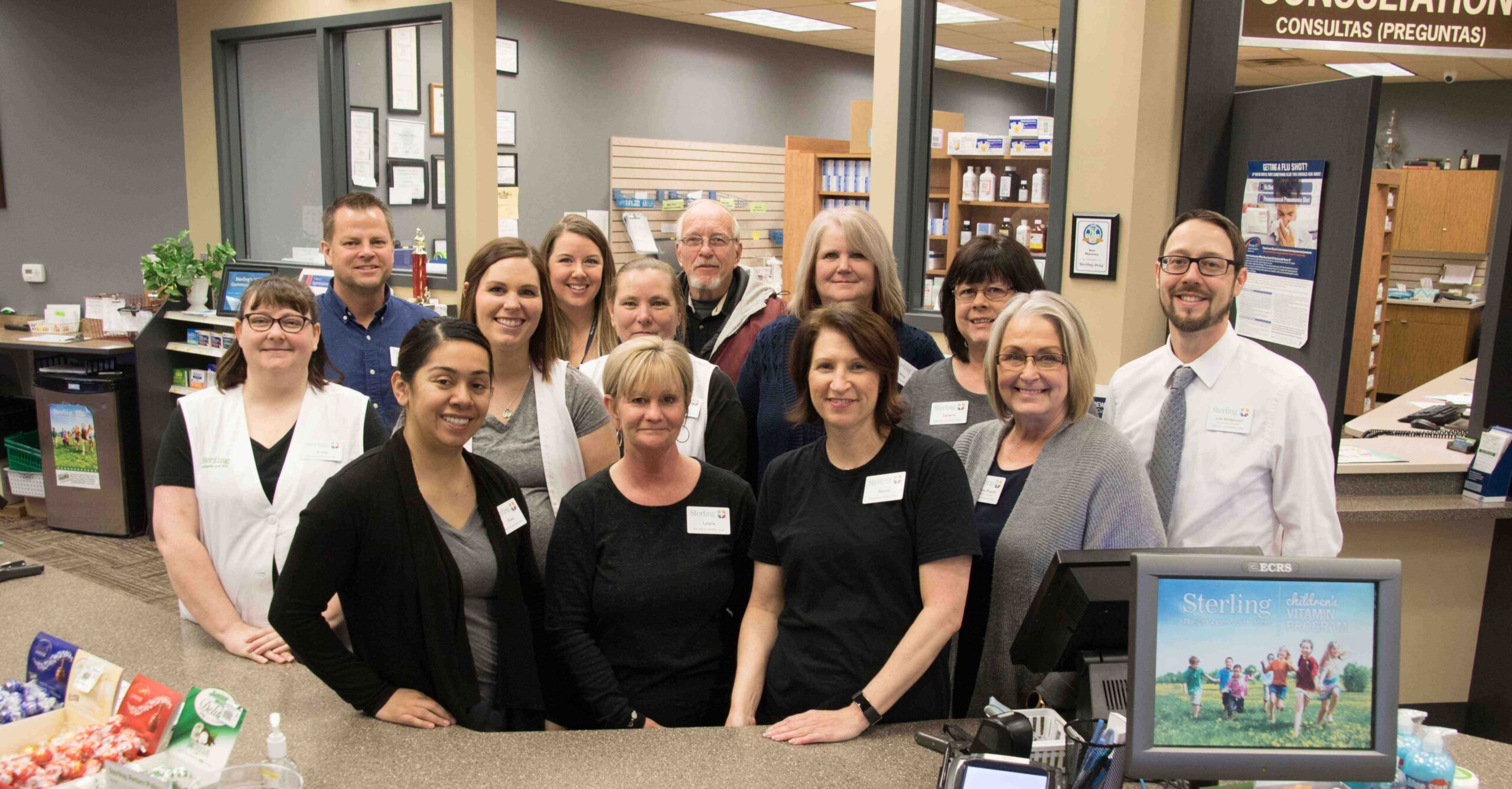 The Worthington Pharmacy team standing behind the store counter